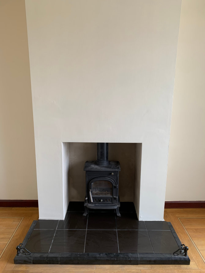 Fireplace restored using Adaptavate Medium natural lime plaster