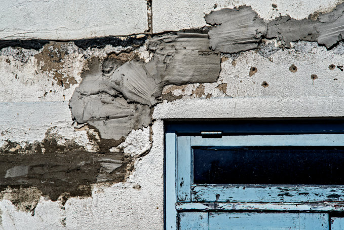 Plaster repair being completed on a damaged interior wall